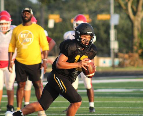 Sealy quarterback D’vonne Hmielewski rolls out of the pocket during the Tigers’ home scrimmage against Columbus last Thursday on Mark A. Chapman Field. COLE MCNANNA