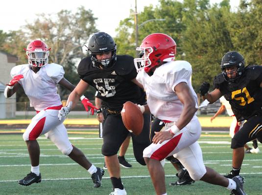 Richard Hahn bears down on the Columbus quarterback during Sealy’s scrimmage against the Cardinals on Mark A. Chapman Field at T.J. Mills Stadium Aug. 20. COLE MCNANNA