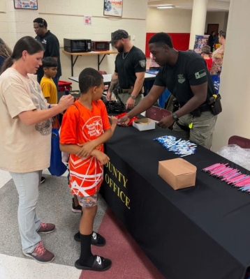 Members of the Austin County Sheriff’s Office and Youth and Family Services served the community during the Back-To-School Fair last week at Bellville High School. COURTESY PHOTO