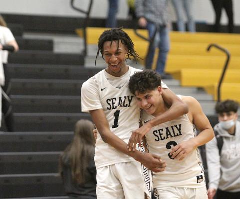 Sealy seniors Donte Beasley (1) and Nick Martinez (3) celebrate Martinez’s winning shot that lifted the Tigers over El Campo in overtime Friday night at home. The win moved Sealy to 4-4 with two games remaining in the regular season. (Cole McNanna/Sealy News)