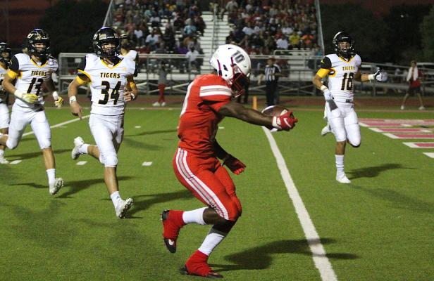 Bellville senior running back Richard Reese extends the ball over the goal line for his first of five touchdowns Friday night that helped the Brahmas take down Sealy 42-7 in the Pasture of Pain. COLE McNANNA