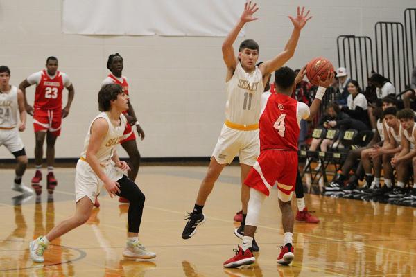 Tiger junior Dillon Dornak leaps to defend a pass from El Campo’s Jake Samaripa in the first quarter of the District 24-4A tilt at Sealy High School Jan. 14. COLE MCNANNA