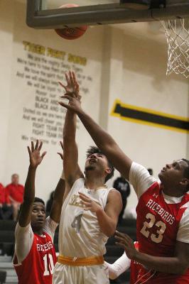 Sealy junior Mason Klotz goes up for a contested layup in the first half of the Tigers’ district-opening game against El Campo last Friday at home. COLE MCNANNA