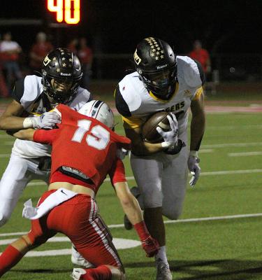 Sealy senior Thomas Clark advances a catch up field while classmate Graham Samonte throws a block on Bellville’s Carson Peschel (19) Friday night at the Pasture of Pain. COLE McNANNA