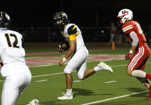 Tiger senior Connor Krenek extends through the second level en route to an 18-yard touchdown rush in the fourth quarter of Sealy’s rivalry district game against Bellville Friday night on the road. COLE McNANNA