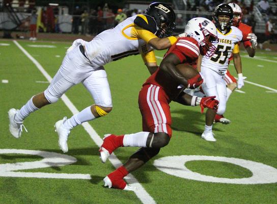 Bellville senior running back Robert Briggs fights for extra yards while Sealy junior Mason Klotz attempts to drag him down from behind during the rivalry matchup at the Pasture of Pain Friday night. COLE McNANNA