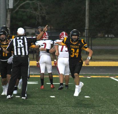 Sealy's Jeffrey Neu celebrates a turnover in the first game of the season Aug. 27. The Tigers collected three more takeaways in Friday's 40-30 win over Navasota. COLE McNANNA
