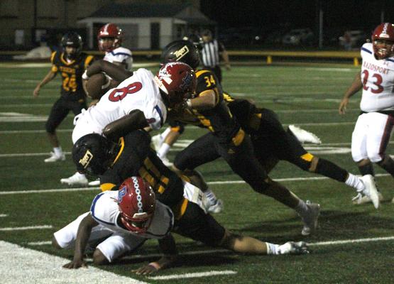 The Tiger defense converges on Brazosport’s Devaughn Davidson to complete the tackle in the first half of the season-opening game against the Exporters Friday night on Mark A. Chapman Field at T.J. Mills Stadium in Sealy. COLE McNANNA
