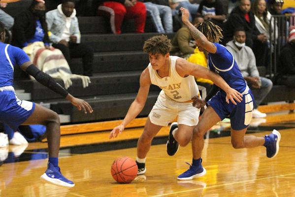 Tiger junior D’vonne Hmielewski looks to split a double team from Navasota during the district contest at Sealy High School Jan. 21. COLE McNANNA
