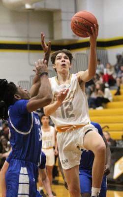 Sealy senior Logan Eschenburg drives the lane for two of his five second-quarter points that tied the game at 15 points apiece heading into halftime during the Tigers’ district game against Navasota at home last Friday. COLE McNANNA