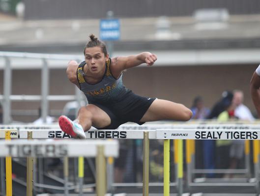 Tiger junior Emmanuel Aguilar competes in the 110-meter hurdle dash during last Wednesday’s Area Championship at Sealy’s T.J. Mills Stadium. Aguilar grabbed second in the race. (Cole McNanna/Sealy News)