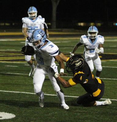 Sealy senior Connor Krenek drags down Sweeny quarterback Trace Holmes in the first half of the Tigers’ district tilt against the Bulldogs Friday night at T.J. Mills Stadium. Sealy won 65-33. COLE McNANNA