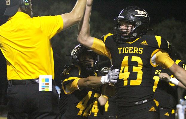 Sealy junior William Forrester (43) celebrates a fumble recovery with Head Coach Shane Mobley during the Tigers’ home district game against Sweeny Oct. 22, 2021, at T.J. Mills Stadium. Forrester was recently announced as a member of the Padilla Poll All-State second-team defense for Class 4A-D2. COLE McNANNA