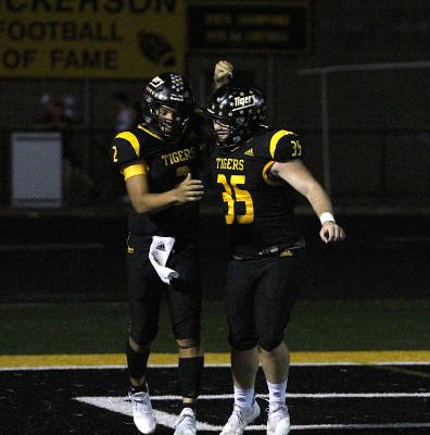 Tiger junior quarterback D’vonne Hmielewski is congratulated by senior running back Ethan Hart after Hmielewski’s 38-yard scrambling touchdown run in the third quarter of Sealy’s district win over Sweeny at T.J. Mills Stadium. COLE McNANNA