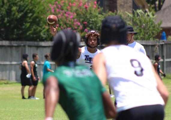 Sealy quarterback D’vonne Hmielewski unloads a throw intended for receiver Reid Miller (9) during the Tigers’ 7-on-7 exhibition contest against Mayde Creek at Taylor High School June 23. COLE McNANNA