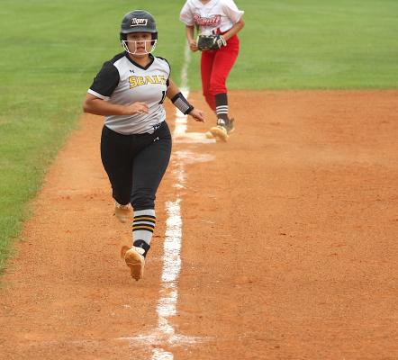 Lady Tiger senior Kayla Camacho scampers down the third-base line to score on a passed ball during Sealy’s penultimate game of the regular season against Royal on the road Monday afternoon.
