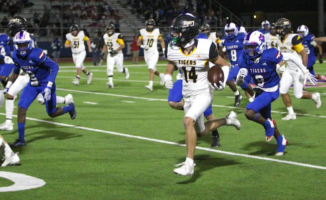 Sealy junior receiver Haden Wernecke hits the open field and outraces the Wharton Tigers on the game-opening score in the first quarter of the Tigers’ district road game Friday night. COLE McNANNA