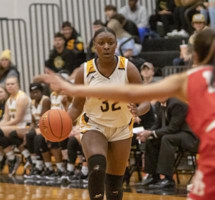 Sealy senior DJ Johnson advances the ball up court in the first half of the Lady Tigers’ home district game against Bellville last Friday.