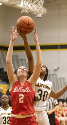 Brahmanette junior Sybil McKay and Lady Tiger junior Jasmyne Joiner battle for a rebound in the fourth quarter of last Friday’s district matchup of rivals at Sealy High School.