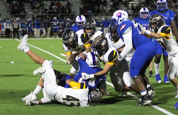 A streak of Sealy Tigers converges on a Wharton ball carrier for a tackle in the first half of the penultimate regular-season game at Eddie Joseph Memorial Stadium. COLE McNANNA