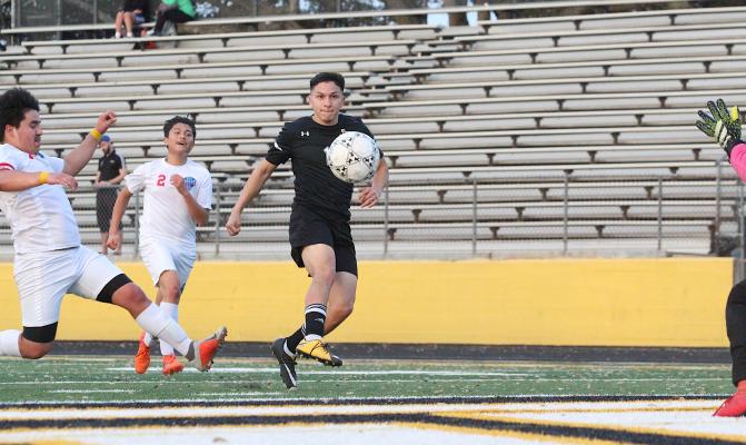 Sealy senior Ricky Avila lifts a shot on net during a district showdown with the Houston Harmony School of Discovery Feb. 26 on Mark A. Chapman Field at T.J. Mills Stadium. Avila netted a goal in each of the Tigers’ two playoff wins to begin the postseason. (Cole McNanna/Sealy News)