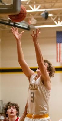 Tiger sophomore Reid Miller leaps to grab an offensive rebound in the second quarter of Sealy’s district battle with Bellville last Friday at home.