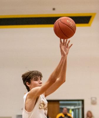 Sealy senior Logan Eschenburg launches a three-pointer as part of a 10-point third quarter that helped the Tigers down rival Bellville 45-29 last Friday at home. COLE McNANNA