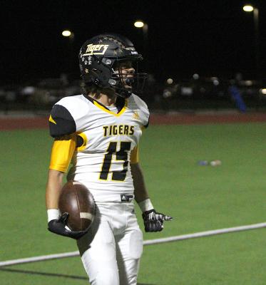 Julius Aguilar yells in excitement after he secured a spinning catch for a touchdown in the third quarter of the Tigers’ district road game in Wharton Friday night. COLE McNANNA
