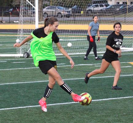 Sealy freshman Lani Krenek sends a ball to the other end during a Dec. 16, 2021, practice at T.J. Mills Stadium. COLE McNANNA