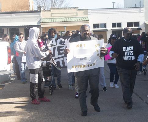 Rev. DJ Johnson leads a silent protest march down to Austin County Justice Center during the Lindemanm's controversy. File photo