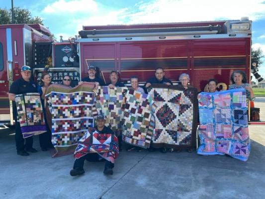 Standing (from left) Fireman Eric Ordner, Lilly Svec, Sandy Lewis, Firemen Caleb Weaver and Randy Ostwald, Judith Washburn, Fireman Joshua Bermea, Deanna Creekmore, Susie Stegal and Teresa Henry. Seated Fireman Dio Valdez.