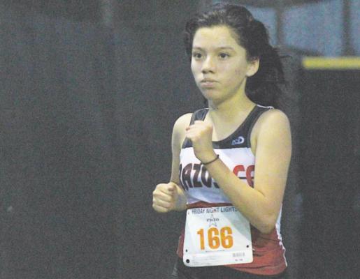 Brazos junior Esmeralda Garcia eyes the finish line during the Frio Friday Night Lights meet at Sealy High School Sept. 20. Garcia won her fourth individual race of the season in the final regular-season meet before district.