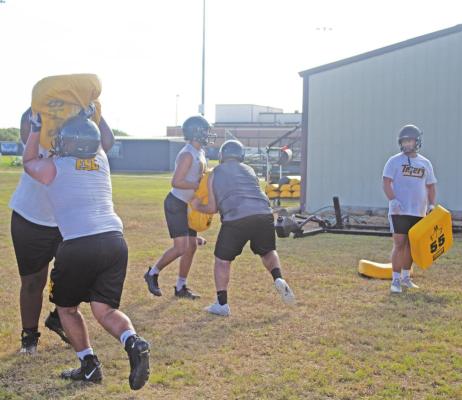 Lineman for the Sealy High School Tigers football team attack the bags as they work on blocking techniques. JASON MANAGO-GRAVES