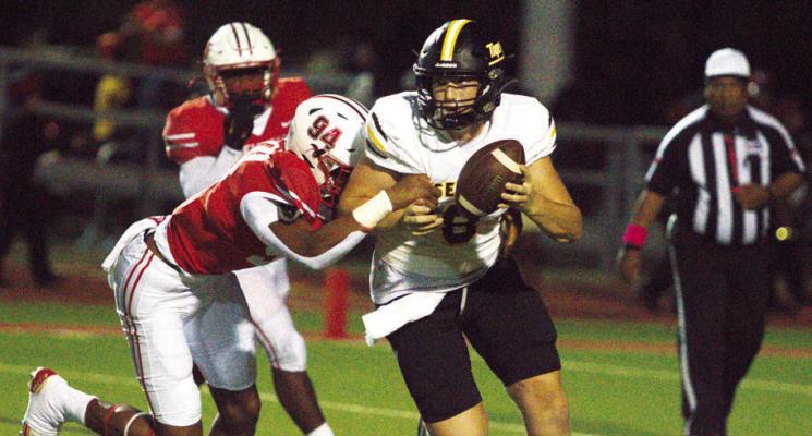 Sealy’s Reid Miller tries to escape the Bellville defense during this year’s matchup.