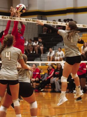 Sealy’s Ashley Owen battles with a pair of Royal defenders at the net. Sealy swept Royal in straight sets for the district win last Friday. PHOTOS BY JIMMY GALVAN