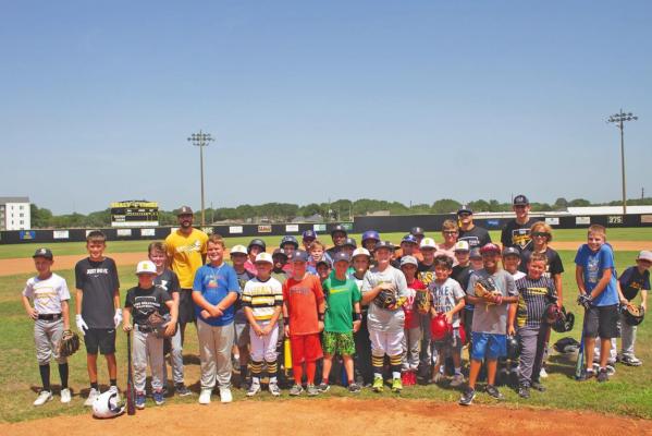 Incoming third through seventh graders pose for a picture after they complete the first day of Boys Baseball camp at Aubrey Stuessel Stadium on June 13. PHOTOS BY JASON MANAGO-GRAVES