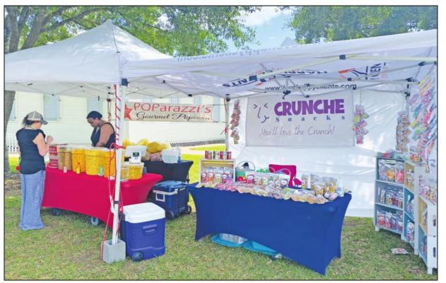 Lani Miller, owner of Twisted Willow in Sealy, purchases popcorn from Kayla Alderson of POParazzi’s Gourmet Popcorn at the film festival at Liedertafel Hall on Friday. Vendors sold snacks to give the event a real ‘movie-theater’ vibe. RAE DRADY