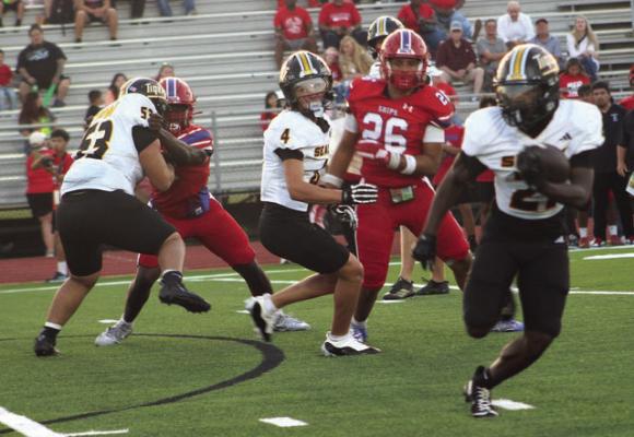 Sealy running back Caleb Labba, 21 with football, finds running room behind the blocking of Jose Gomez, 53, and Weston Cryan, 4. Labba ran for 72 yards and scored two touchdowns in Sealy’s win over Brazosport.