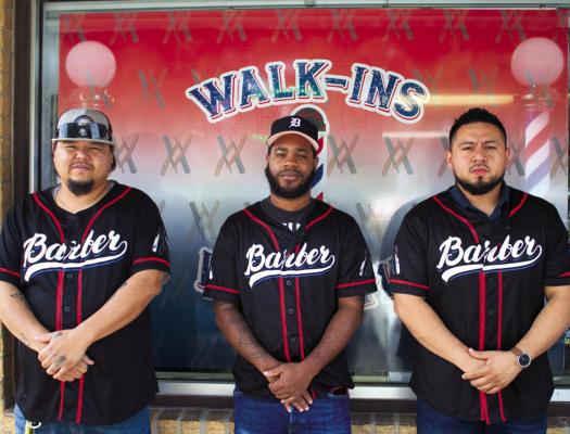 Left to Right: Barbers Jerry Aldape, Akeem Ince and Eddie Villasana pose in front of the Rustic Blade as they get ready to hop back inside and cut hair for the day.