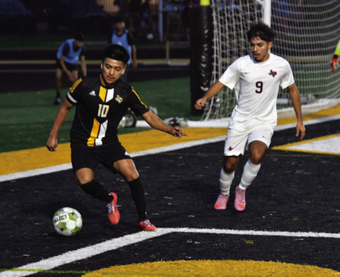 Miguel Rodriguez keeps the ball away from the defender while trying to make a play at the goal. COURTESY PHOTO