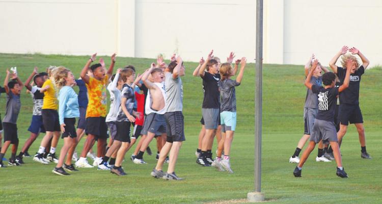 Sealy student-athletes warm up for the second day of the Sealy High School Football Camp Tuesday, July 27. PHOTOS BY COLE McNANNA