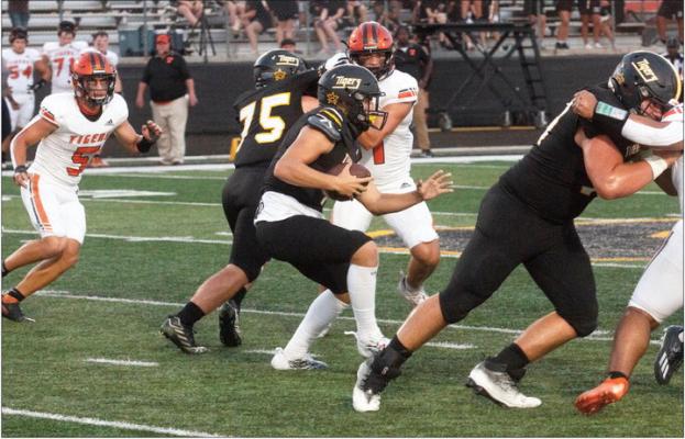 Sealy quarterback Kane Killough looks for running room during first-half action.