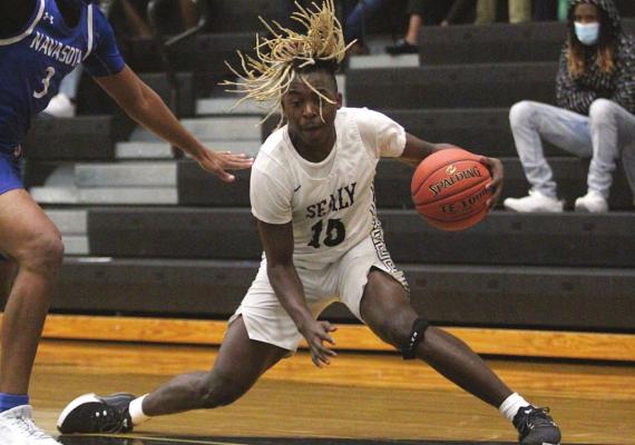 Sealy senior Draper Parker executes a crossover to get separation from a Navasota defender during the District 24-4A tilt between the Tigers and Rattlers at Sealy High School on Jan. 15. (Cole McNanna/Sealy News)