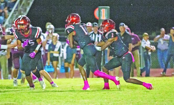 Brazos quarterback Bryson Bennett (2) hands the ball off to Jarvse Dickerson during the Cougars big win over East Bernard. PHOTOS BY JIMMY GALVAN