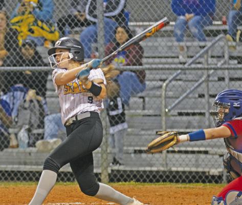 Jacie Kainer drives a ball to the outfield during last Friday’s game. PHOTOS BY JIMMY GALVAN