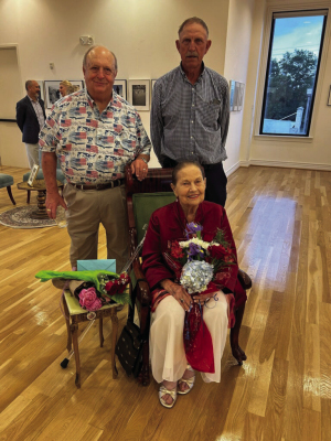 Clarice Marik Snokhous just had the opening reception for her photography exhibit at the Czech Center Museum in Houston, Saturday, May 9 . Edward Klecka is standing on the left, Clarice Marik Snokhous is seated, and Edwin Marik, Clarice's first cousin from East Bernard. Bernard, is standing on the right. Courtesy photo