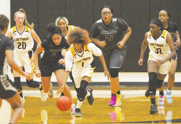 Sealy sophomore Taniah Coleman picks up a loose ball and leads the fastbreak in the second quarter of the Lady Tigers’ season opener last Tuesday at home against the Westside Wolves. COLE McNANNA
