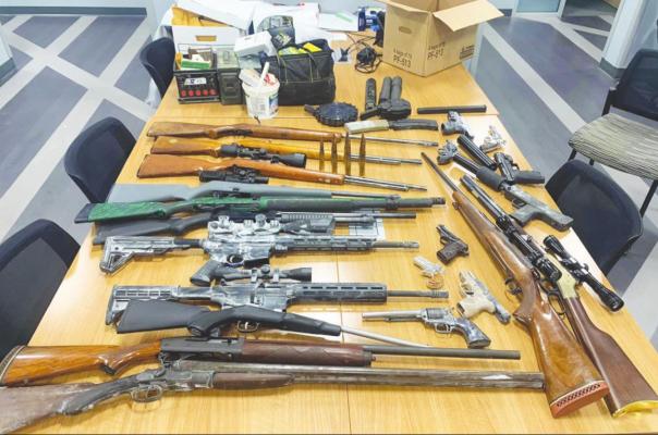 Austin County’s Special Response Team aided the Waller County Sheriff’s Office in seizing 22 guns, four suppressors, ammunition and more Jan. 6. CONTRIBUTED PHOTO in seizing 22 guns, four