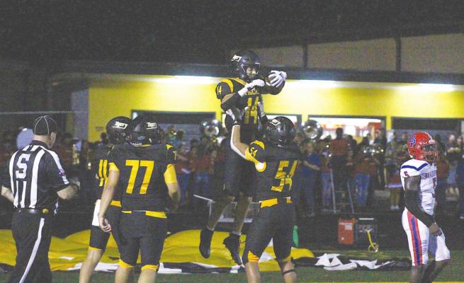 Jonathan Monterroza (54) lifts Haden Wernecke (14) after the receiver’s second score of the first half against Brazosport at T.J. Mills Stadium Friday night. COLE McNANNA