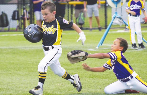 An all-out effort from a La Grange infielder was not enough to tag out Jackson Gilbert who retreated to first base after a hit during Sealy’s pool play game last Saturday, June 5. COLE McNANNA
